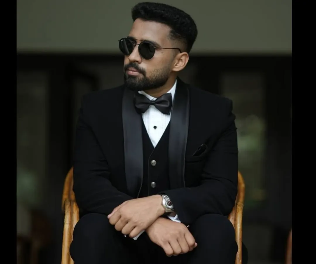 The classic black tuxedo, redefined. This bespoke three-piece suit is crafted from premium fabric, featuring satin lapels and a tailored fit that ensures a sharp, timeless look for any formal occasion.