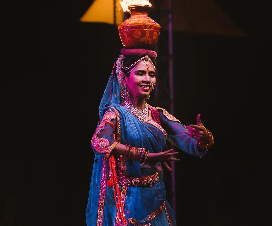 A performer balances a pot of fire on her head during a cultural dance. Capturing the intensity and skill of artists in challenging low-light situations is what I do best, freezing the peak of the action.