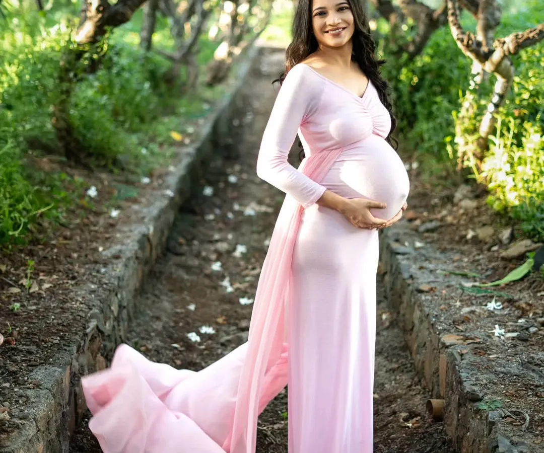 There's something so magical about an outdoor maternity shoot. We found this beautiful tree-lined path in a Mumbai park, and the soft natural light was perfect. This flowy pink gown, which I provide, added just the right touch of fairytale elegance to her solo portrait.