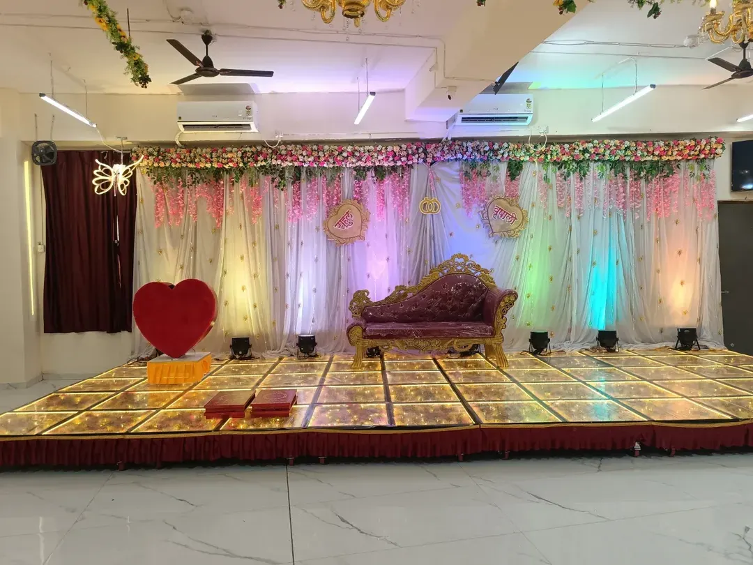 A beautiful stage setup for an engagement ceremony at our Badlapur hall. The elegant divan, floral backdrop, and illuminated LED dance floor create a perfect setting for your special moments. This is a popular choice for a small wedding reception venue.
