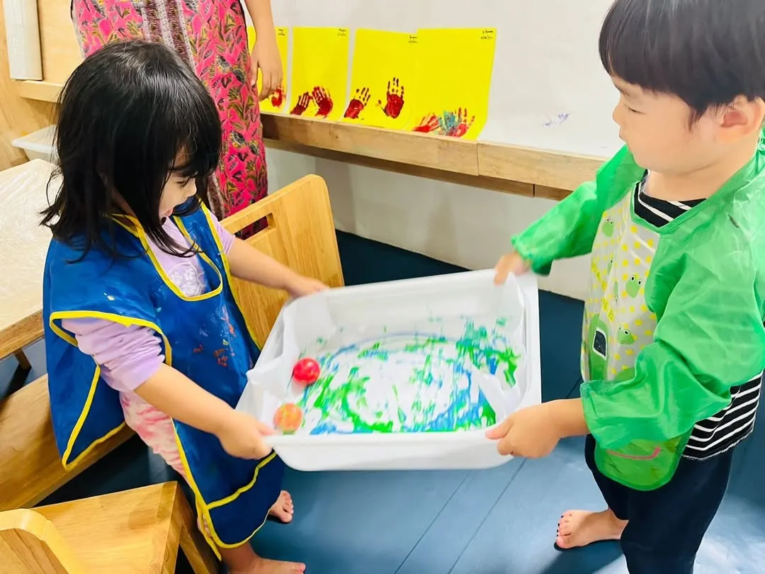 Collaboration is at the heart of our activities. In this marble painting project, two children work together, learning to coordinate and communicate while creating something beautiful. This is a great example of our focus on social skills enrichment through play.