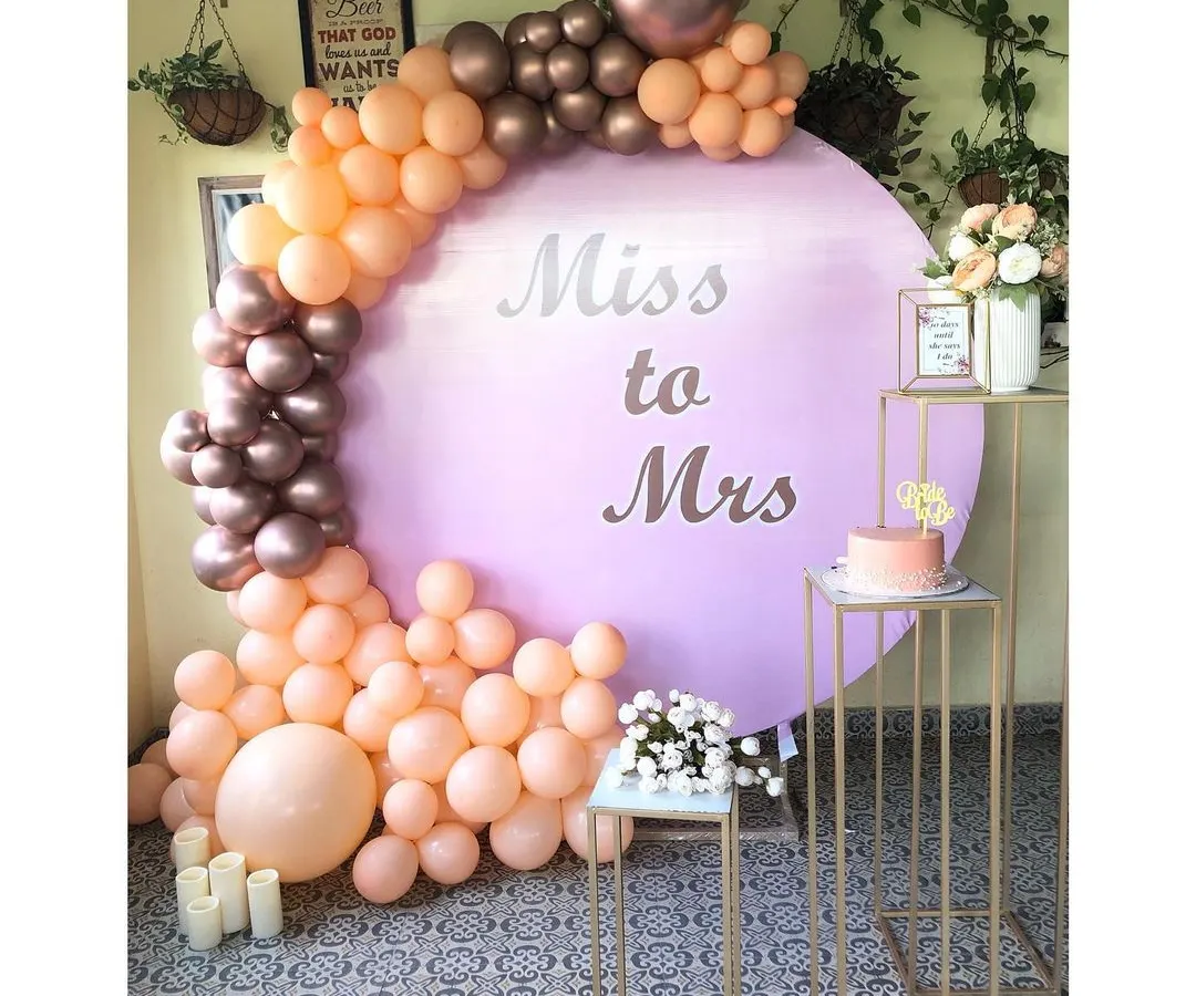 For the bride and her tribe, I create chic, photo-ready spaces. This popular 'Miss to Mrs' circular backdrop, paired with a custom peach and rose gold organic balloon arch, is perfect for a modern bridal shower.