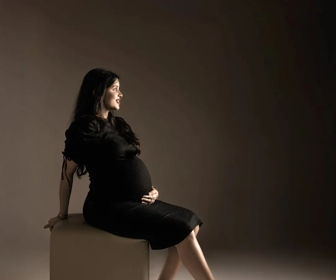 A quiet moment of reflection for the mama-to-be. We use dramatic lighting in our studio to create these powerful, fine art maternity portraits that feel both timeless and deeply personal.