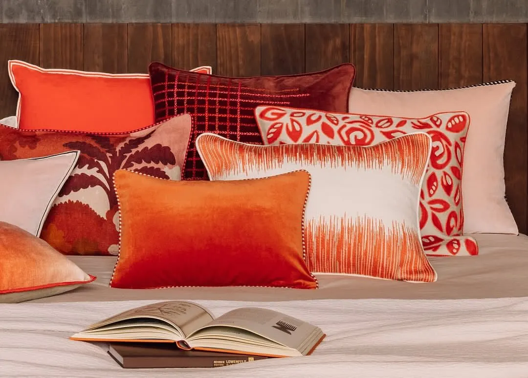 A lavish assortment of our artisanal cushions, each a masterpiece of texture and colour. This collection features vibrant ombre velvets, intricate embroidery, and bold graphic prints, demonstrating how we use these essential accents to layer personality and luxurious comfort into any interior scheme.