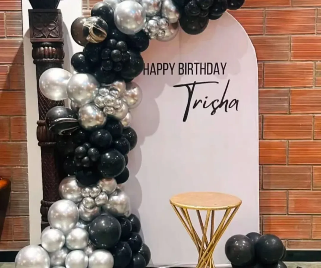For a sleek and modern birthday celebration, I designed this black and silver balloon arch against a clean white backdrop. I also added a custom vinyl name decal for a personal touch, making it a great photo spot.