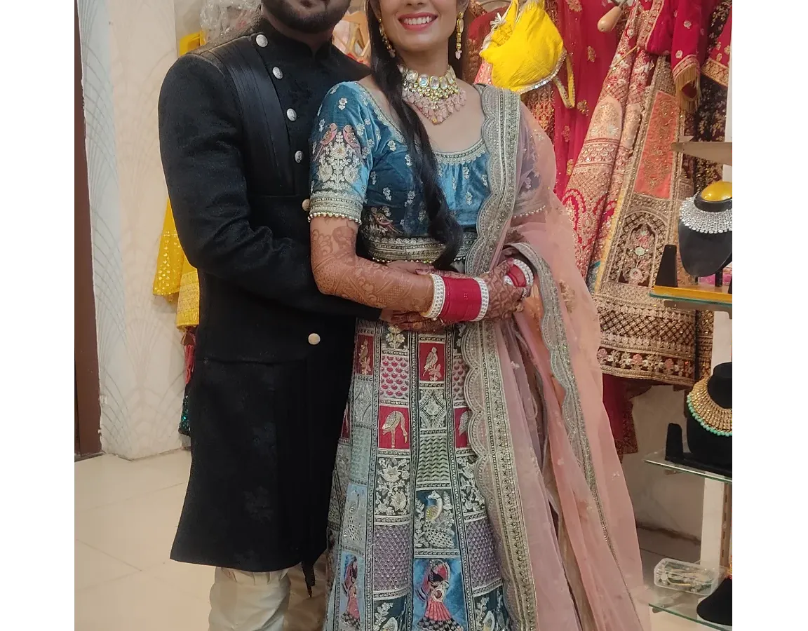 Here’s how I help couples create a perfectly coordinated look. This bride’s unique Doli Barat lehenga pairs beautifully with the groom's classic black bandhgala sherwani.