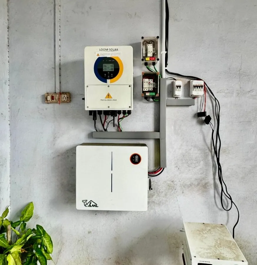 This is the heart of your energy independence. A clean and compact indoor setup showing our smart hybrid inverter and the wall-mounted CAML lithium battery, working together to provide 24/7 power.