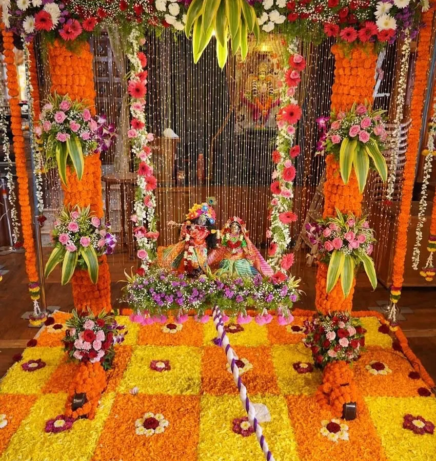 For a truly traditional Janmashtami, we designed this vibrant floral swing (jhoola) and rangoli setup. The combination of bright orange and yellow marigolds with fresh mixed flowers creates a joyful and divine atmosphere perfect for welcoming Kanha.