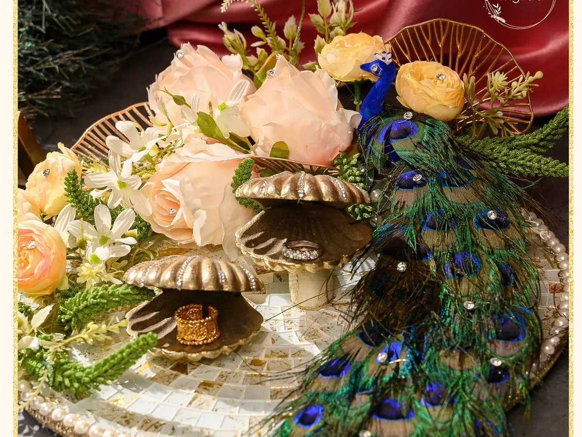 For engagements, I design platters that are as memorable as the moment itself. This piece, from my Ibtidaa collection, features a majestic peacock motif, delicate florals, and shell-shaped ring holders on a mosaic tray, creating a truly regal start to a new journey.