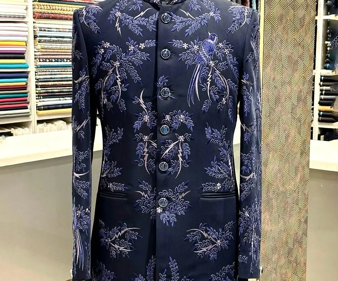 I love blending tradition with a personal touch. This custom navy blue bandhgala features delicate, hand-done bird and branch embroidery, creating a look that is both regal and unique for any formal occasion.