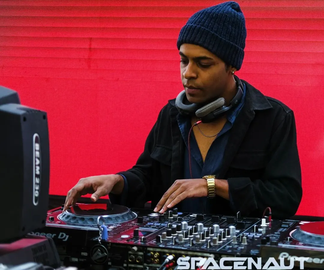 Focused on the mix, ensuring every transition is seamless. Here I am at the decks, using my Pioneer setup to craft the sound for the night.
