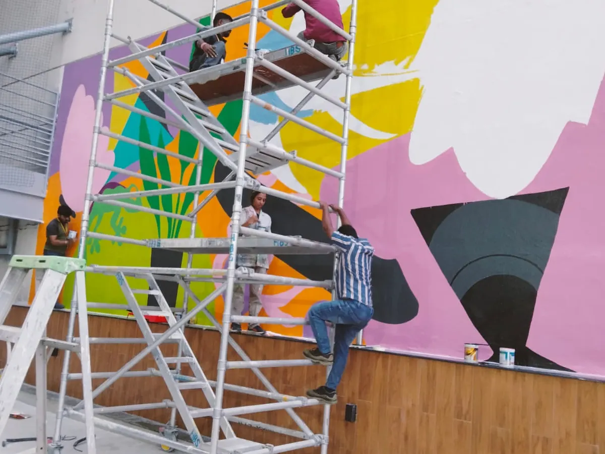 There's a special kind of chaos I live for, and it looks a lot like this. High up on the scaffolding with my incredible team, bringing a massive, vibrant mural to life for a corporate client. We transform office spaces into places of energy and inspiration.