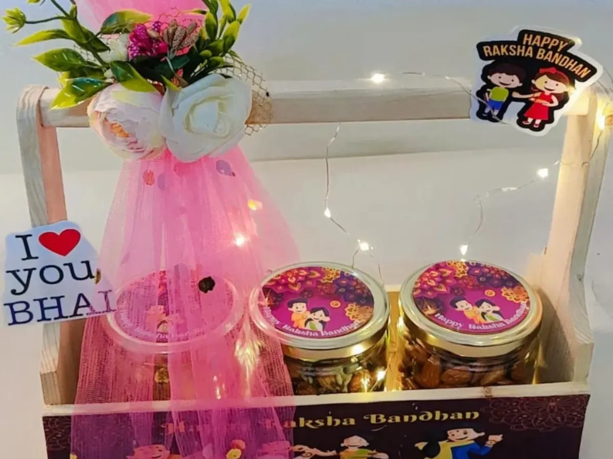 For Raksha Bandhan, I love creating hampers that feel both personal and festive. This wooden basket hamper is a popular choice, lit with delicate fairy lights and filled with jars of cookies and healthy muesli. It’s a complete Rakhi gift set, showing how I combine traditional sentiments with modern aesthetics.
