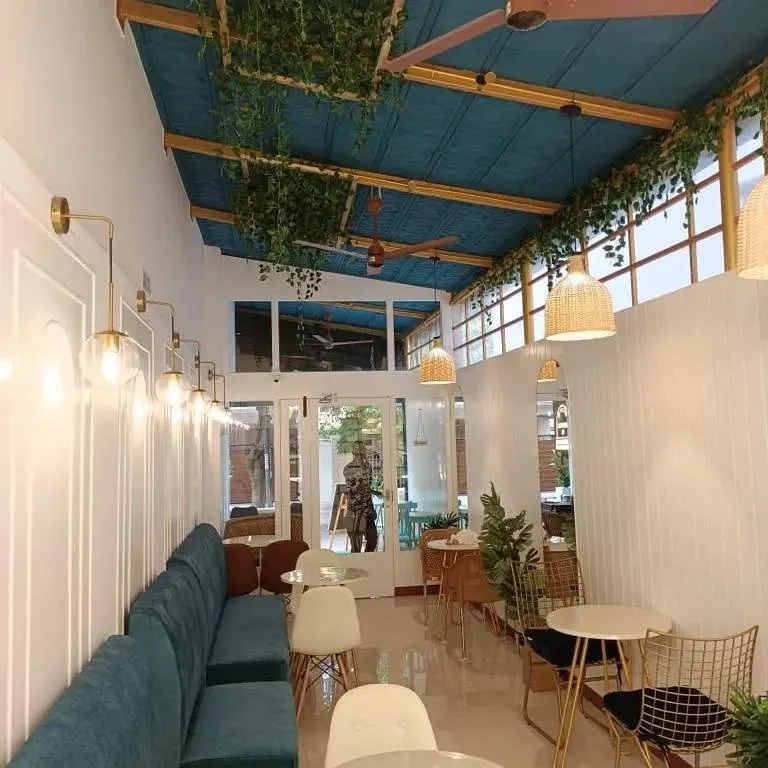 A key part of biophilic hospitality design is integrating natural light and greenery. We designed this cafe to feel bright and airy, using large windows and hanging plants to create a refreshing environment that encourages guests to stay longer.