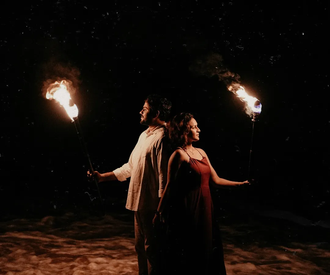 For this pre-wedding shoot in Goa, we used fire torches against the night sky to create a dramatic, cinematic feel. This shot shows how I play with light and shadow to tell a powerful story.