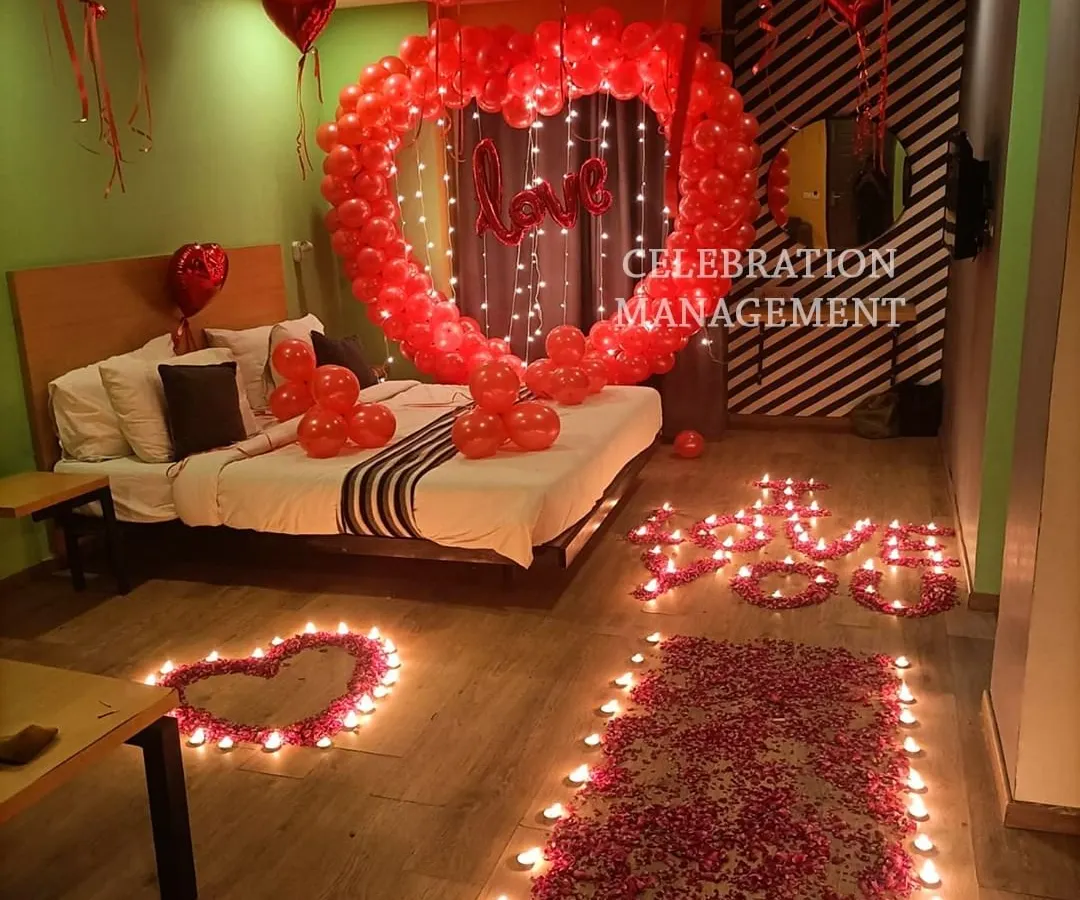 This is the ultimate romantic gesture. We filled this room with love, using a large heart-shaped balloon arch over the bed, a candle-lit pathway of rose petals, and hundreds of red balloons to create a completely immersive and passionate atmosphere.