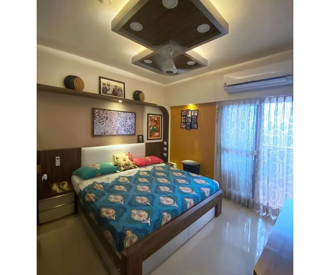 For the Malhotra Apartment, we designed a master bedroom that balances warm undertones with personal touches. The space features custom woodwork, integrated cove lighting in the ceiling, and an accent wall, creating a comfortable and timeless personal sanctuary that has remained stylish for over six years.