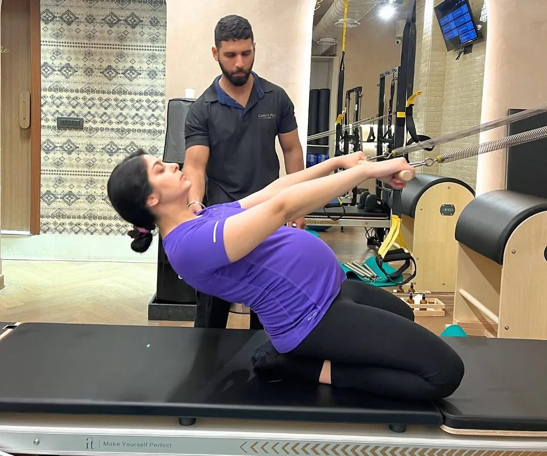 We support mothers through every stage of their journey. This client, at eight months pregnant, is building strength and comfort with a customized prenatal Pilates session, guided safely by our expert instructor.