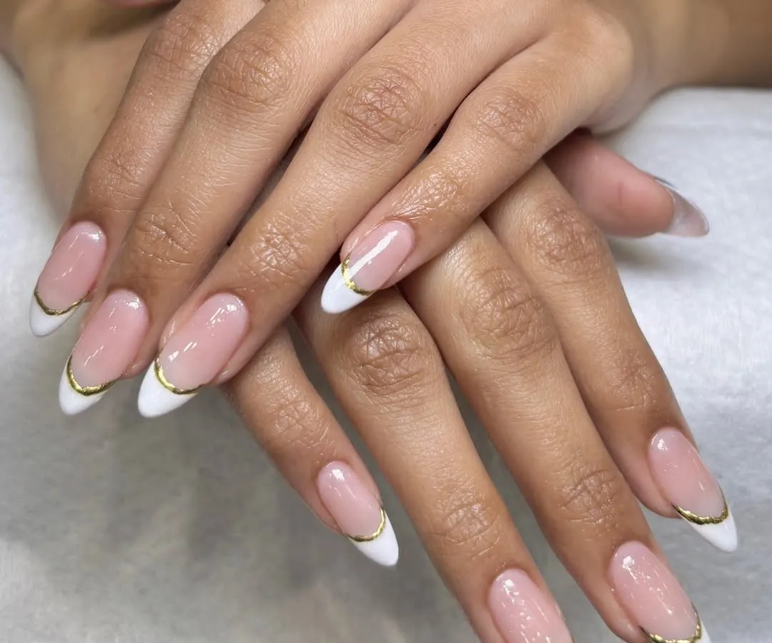 You can never go wrong with a classic French manicure, but I love adding a little twist. This elegant look features a delicate gold chrome line along the tip for a modern and sophisticated finish on these almond-shaped nail extensions.