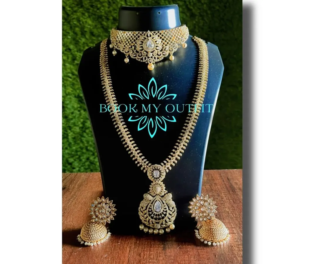 For a more modern reception or party look, I offer sets like this one. It features a beautiful choker and a matching long necklace studded with brilliant white stones that look just like diamonds, paired with elegant jhumkas.