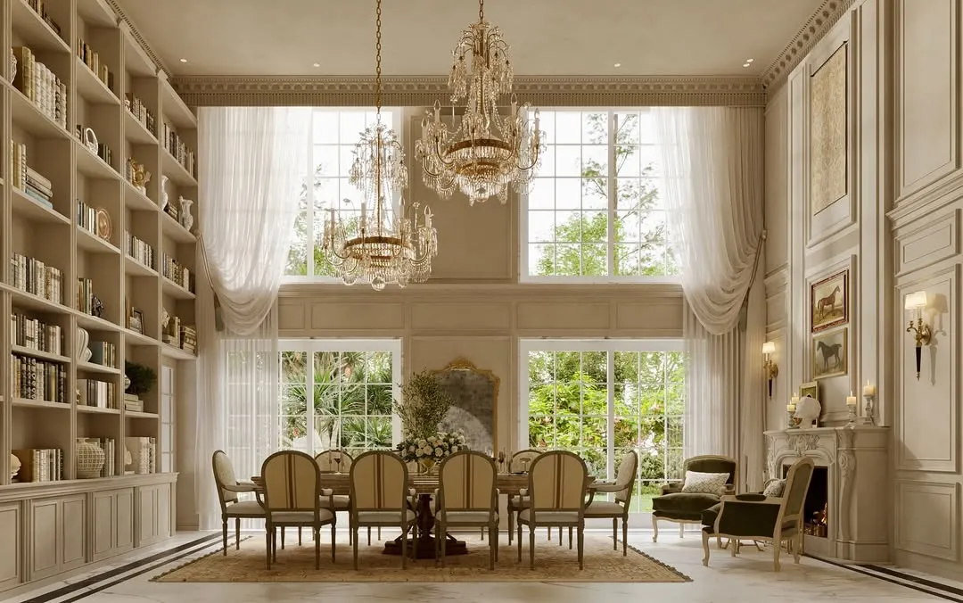 This double-height dining area is a celebration of scale and grandeur. I designed this space with soaring ceilings, intricate wall mouldings, and large crystal chandeliers to create an environment that feels both impressive and inviting for gatherings.