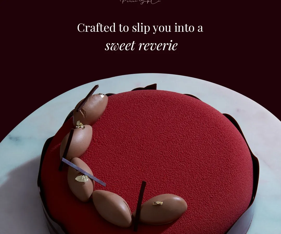 This is my Choco Framboise, finished with a deep red velvet spray. The finish is not just for appearance; it seals the delicate layers inside, preserving the textures of the dark chocolate mousse and sharp raspberry crémeux until you are ready to indulge.