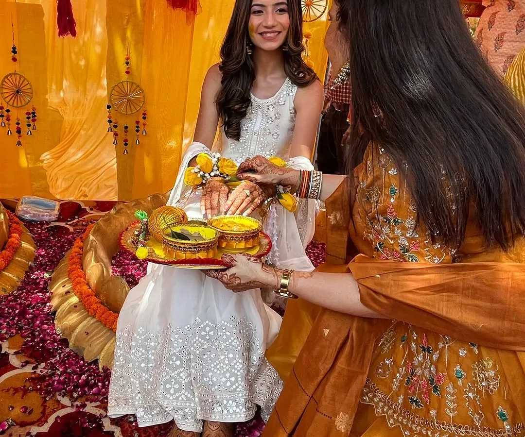 A closer look at Rhea's Haldi ceremony. She chose a subtle yet vibrant white sharara with gottapatti work. I styled it with a delicate matha patti and fresh flower hath phools for a look that was like a dream.