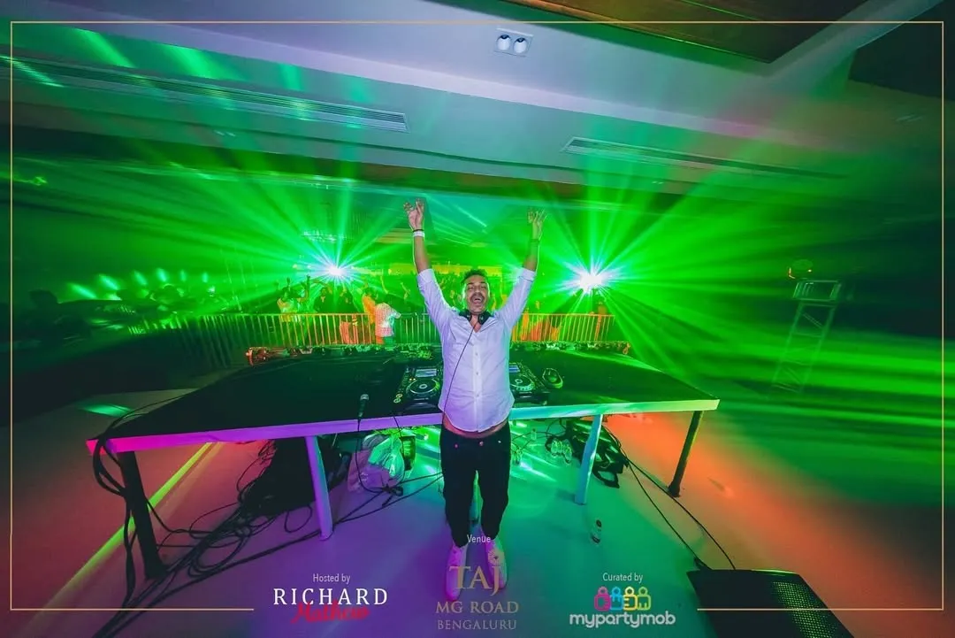 In my element, hands up with the crowd, surrounded by a sea of green lasers. This shot from a New Year's Eve party captures that perfect moment of connection when the music and the lights all hit at once.
