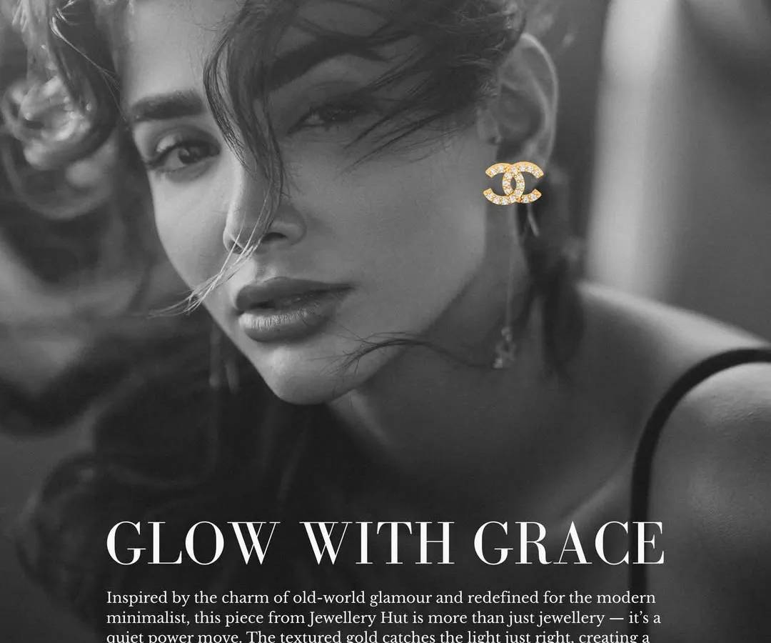 This is the kind of quiet confidence I love to see. Our gold-polished, logo-inspired studs add a touch of old-world glamour to a modern look, proving that true elegance is always in style.