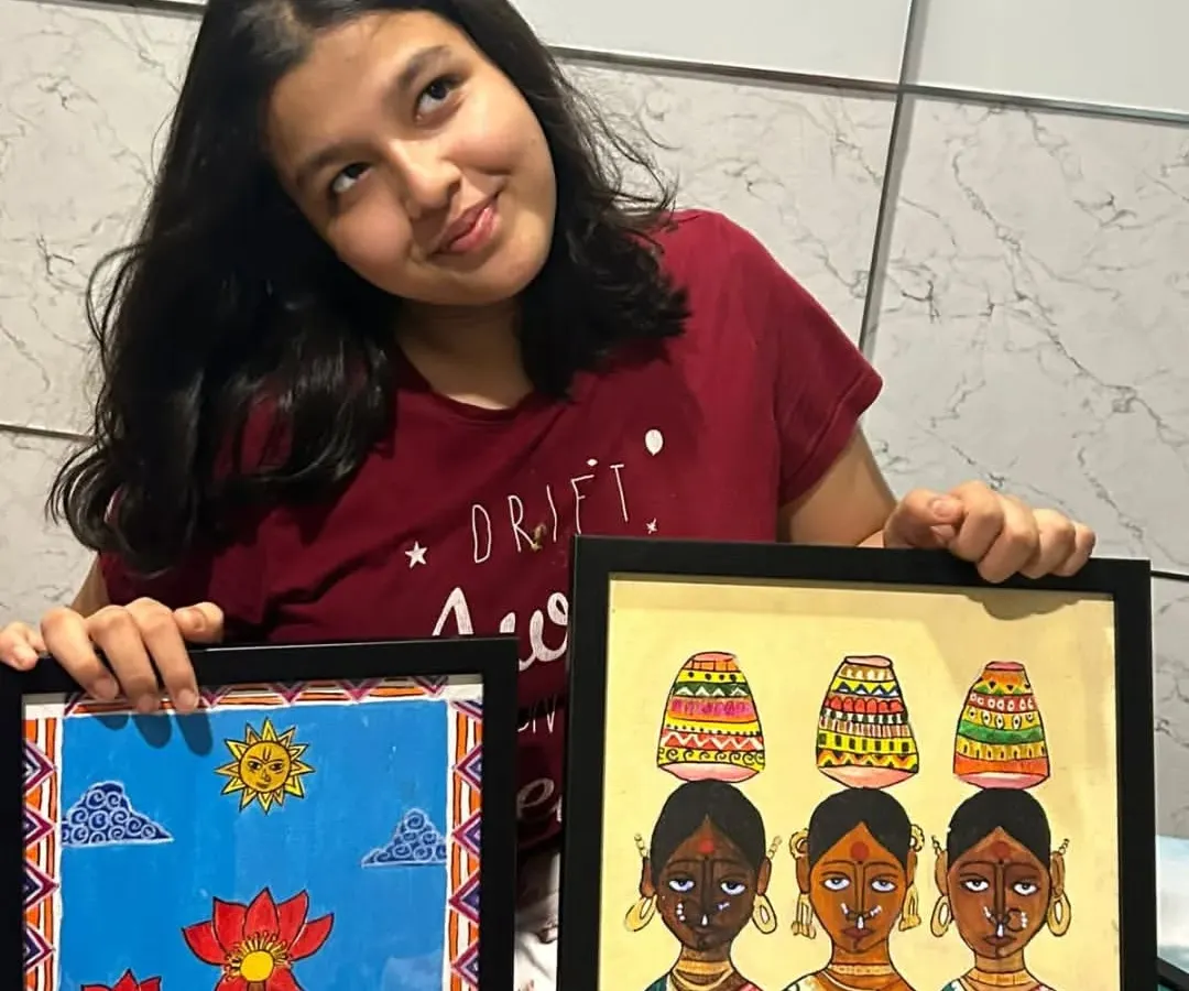 Here is one of our senior students, Adhya from the 11th standard, proudly showing her completed Madhubani paintings. We guide older students in advanced techniques like acrylics on canvas to create professional-quality folk art.