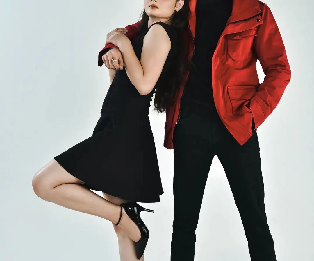 A full-length studio portrait for a couple's fashion shoot. I created coordinated looks with the female model featuring a sharp winged eyeliner and the male model styled for a clean, camera-ready appearance, showcasing my versatility for both male and female portfolio makeup.