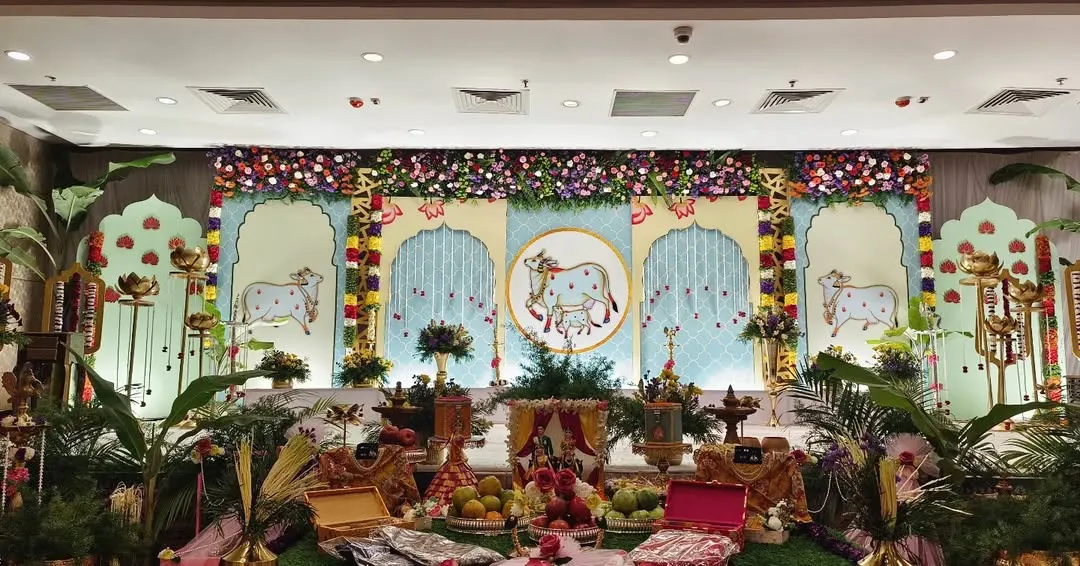 For a truly authentic South Indian ceremony, I designed this unique stage inspired by traditional Pichwai paintings. The backdrop features hand-painted cow motifs, framed by banana plants and brass lamps, celebrating our rich cultural heritage.