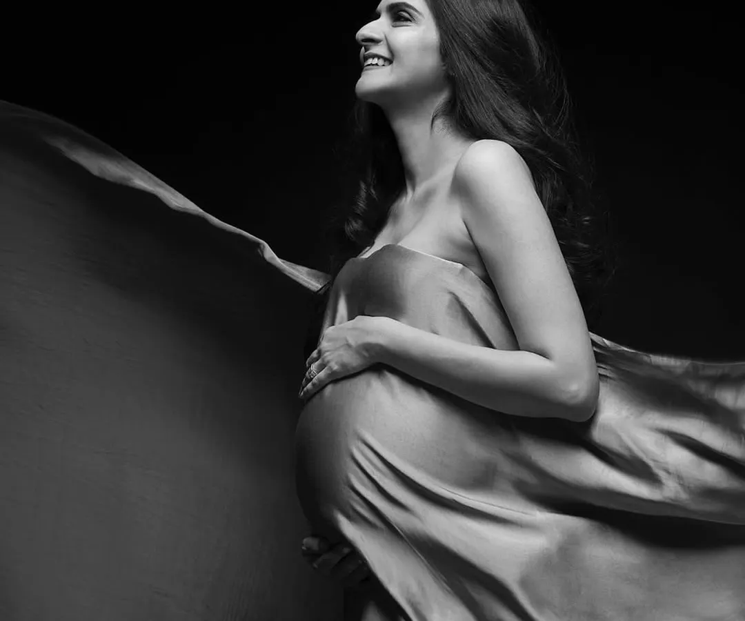 There is so much joy in simplicity. A single piece of fabric and the right light can create a timeless, high-contrast black and white portrait that feels both powerful and happy.