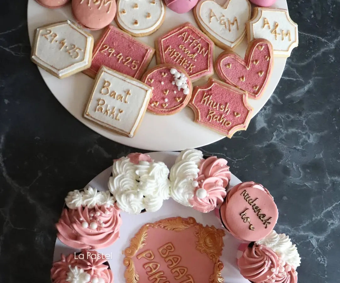My "Baat Pakki" platters are a beautiful way to celebrate an engagement. This set features custom initial cookies, themed cupcakes, and elegant cake pops.