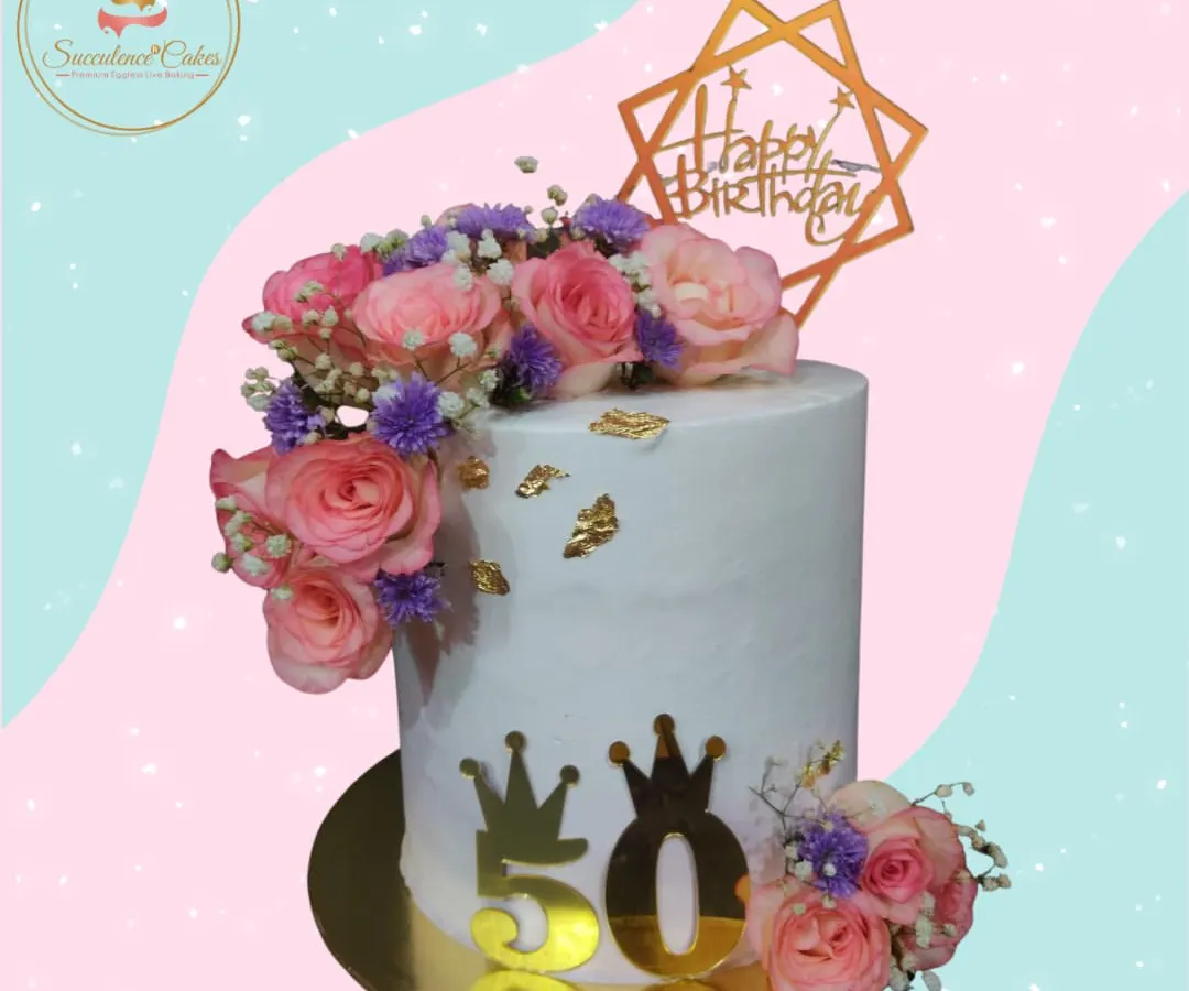 A 50th birthday deserves nothing less than elegance. I designed this tall cake with a cascade of fresh pink and purple roses, accented with delicate baby's breath and edible gold leaf, creating a sophisticated centerpiece for a landmark celebration.