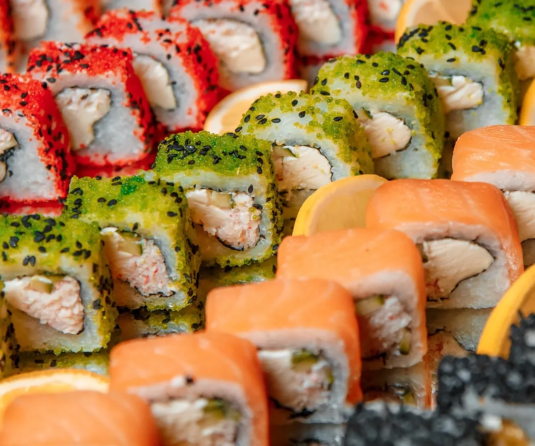 A vibrant and colorful platter of assorted sushi, demonstrating our expertise in Pan-Asian cuisine. Each roll is a testament to our dedication to freshness and authentic flavor, perfect for adding a touch of international sophistication to any wedding or corporate event.