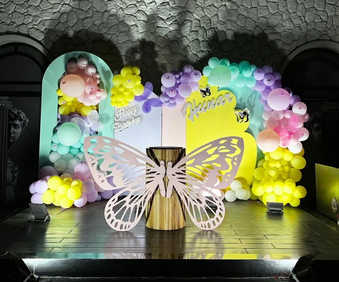 We brought a magical butterfly garden to life for a first birthday party. This whimsical setup features a pastel balloon arch, custom butterfly cutouts, and soft lighting to create an enchanting atmosphere for the little one's big day.