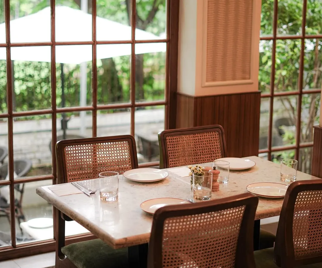 Our cafes are designed to be your comfortable escape. Tucked inside beautiful lifestyle stores, each location offers a serene, elegant setting with large windows that look out onto lush greenery, perfect for a quiet meal or a coffee break.