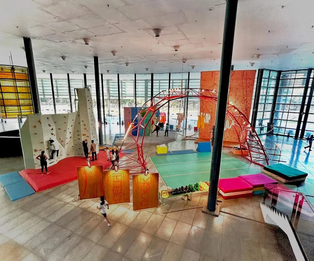 Our gym is a vibrant, open space filled with natural light and a variety of climbing challenges. This wide view shows our bouldering areas, top-rope walls, and the community in action, giving you a sense of the energetic atmosphere you will find here at the Siri Fort stadium.