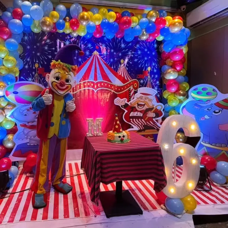 I love bringing big themes to life, like this vibrant Carnival party for a 6th birthday. This setup features a full circus tent backdrop, custom character cutouts, marquee lighting for the age, and even a clown mascot appearance to complete the experience.