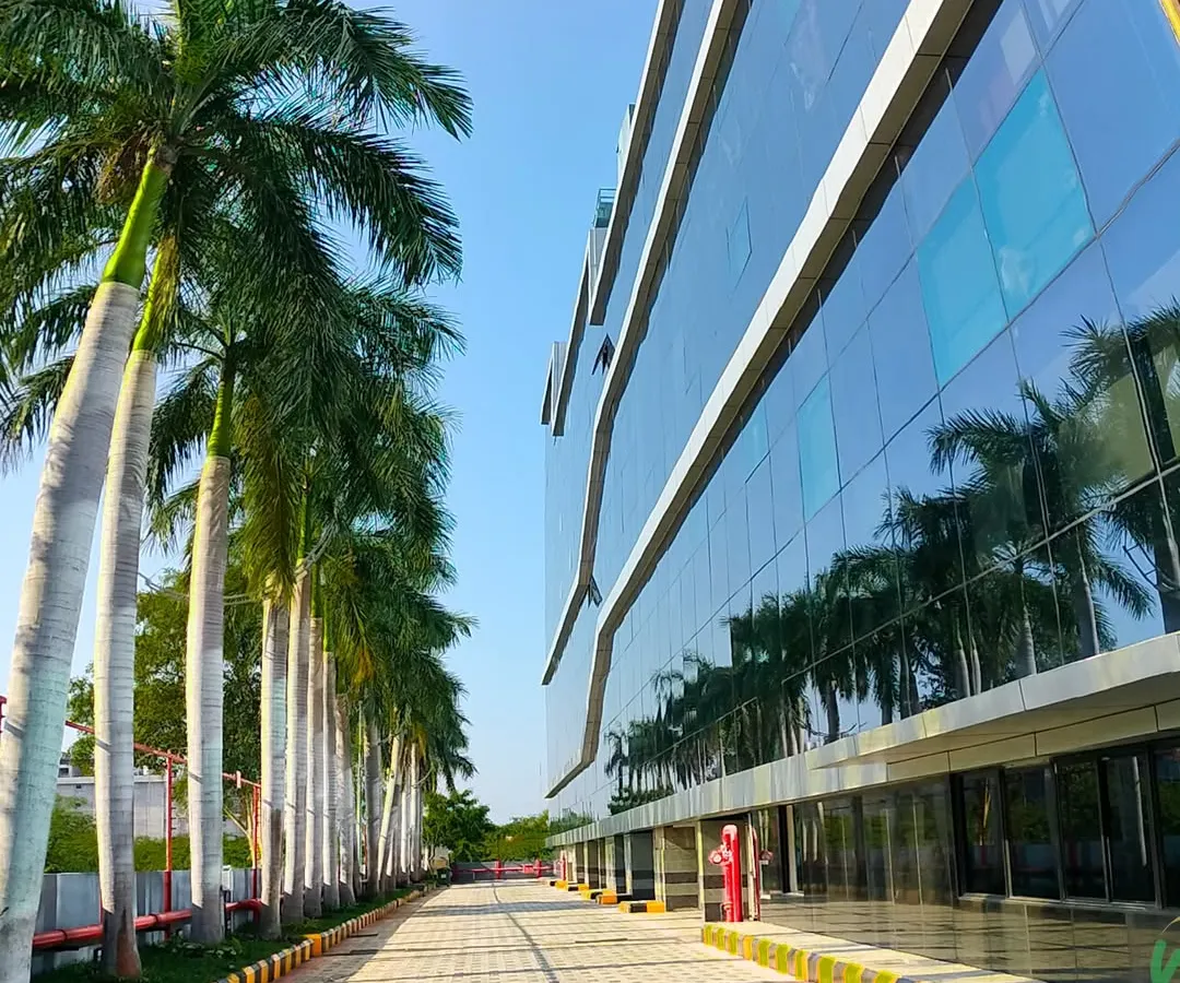We specialize in large-scale commercial landscaping for corporate campuses and IT parks. This project at SIPCOT IT Park features a clean, modern design with royal palms lining the driveway, creating an impressive entrance for employees and visitors.