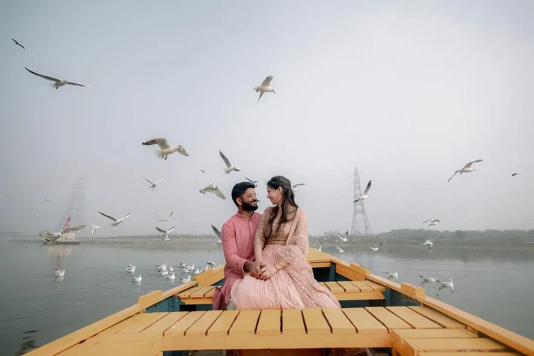 Amidst the morning mist and a flight of seagulls at Delhi's Yamuna Ghat, we found a moment of serene beauty. This is what we live for: capturing the quiet, poetic instances of your love story in the most unexpected and beautiful locations.