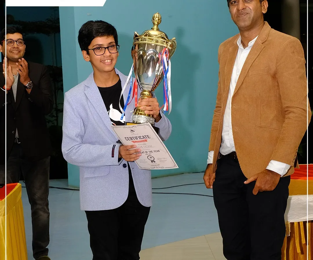 The moment of triumph! A young champion proudly holds his trophy and certificate after a stellar performance at our Chess Carnival, showcasing the rewards of dedication.