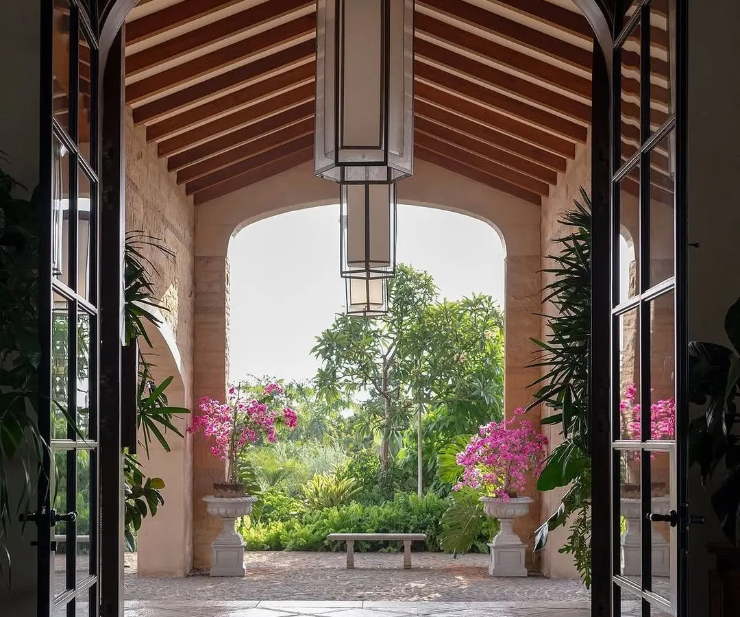 A grand entrance should feel like a welcoming embrace from nature. For this Alibaug villa, I framed the garden view with an archway, creating a living picture that draws you in. The flowering bougainvillea adds a splash of color, promising a serene escape within.