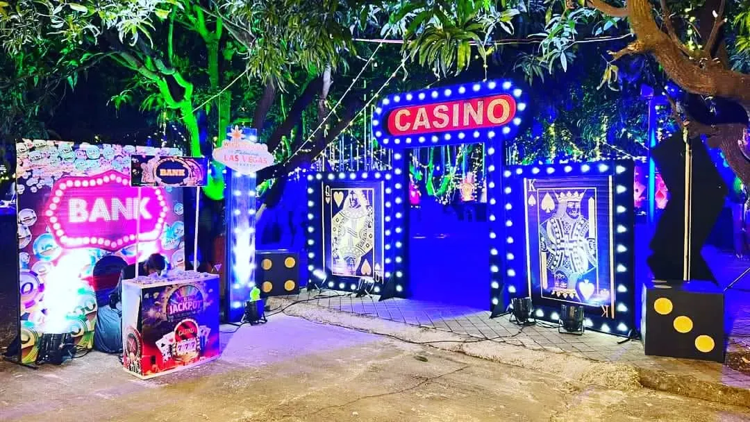 Let me transform your venue with a complete casino theme. This photo shows a grand, lit-up entrance I created for a party, setting the mood for a night of fun and games right from the start.