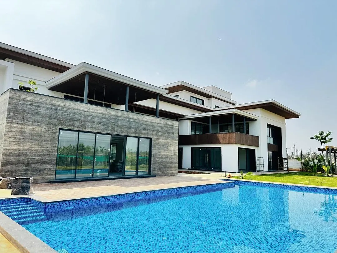 A wide view of a recently completed swimming pool for a modern residence. Our construction process ensures seamless integration with the property's architecture, creating a clean, expansive outdoor oasis perfect for relaxation and entertainment.
