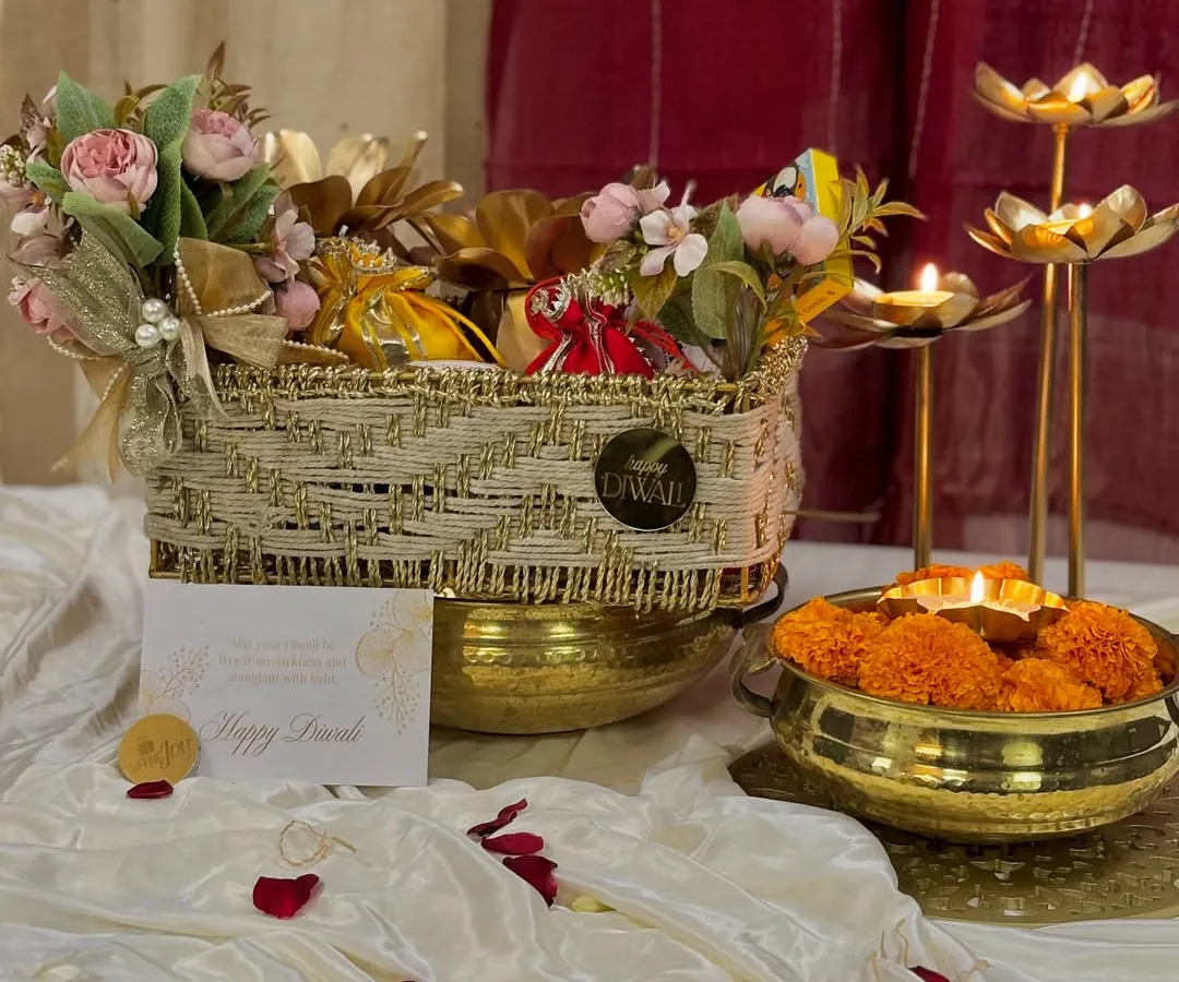 This is where the magic of Diwali comes alive in my 'Rang & Noor' collection. I've combined a beautiful floral arrangement with traditional diyas and gourmet treats in a handcrafted basket, creating the perfect festive gift.
