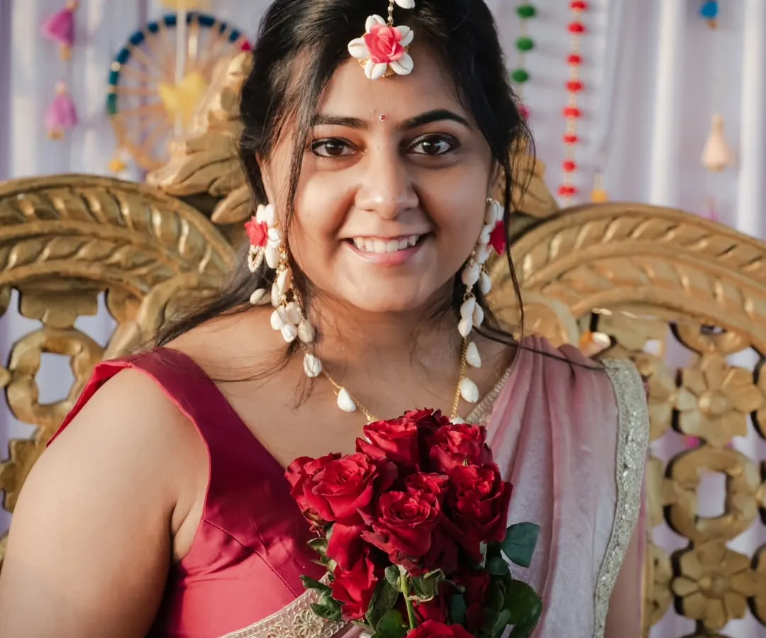 A radiant bridal portrait from a Haldi ceremony. I focused on her joyful expression and the vibrant red roses, creating a beautiful contrast. Capturing the bride's glow during these pre-wedding rituals is one of my favorite parts of the job.