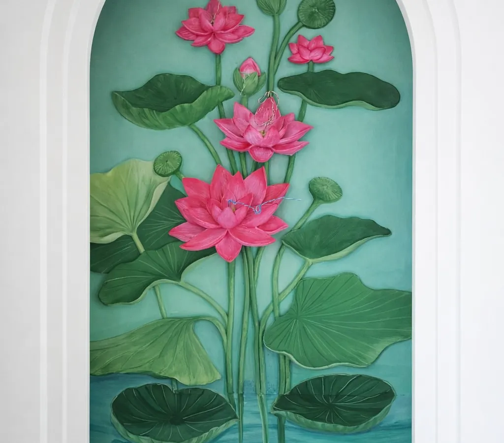 For a sacred space, I created this serene lotus mural to exist in harmony with light and belief. The flowers and leaves are individually sculpted and layered to create a sense of three-dimensional depth and tranquility, making the art feel like it's breathing within the arched niche.