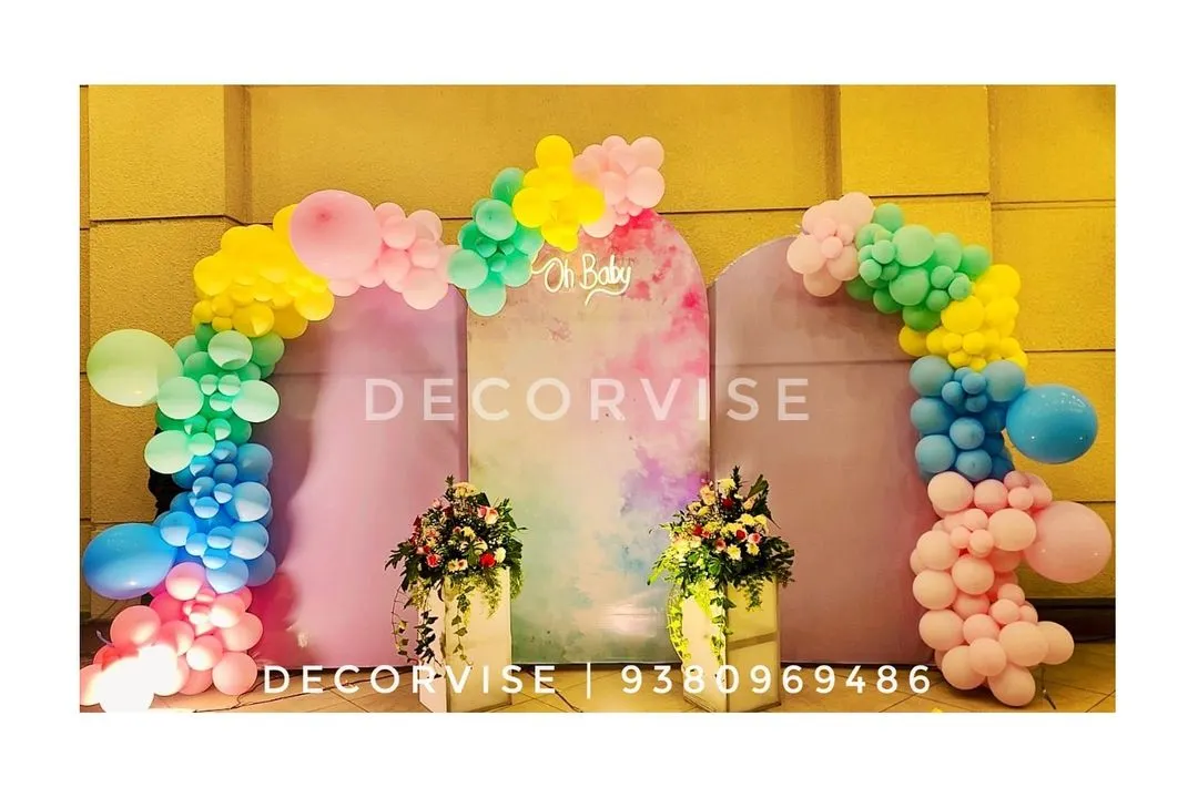 For a modern and chic baby shower, we created this pastel-themed backdrop. It features elegant arched panels with a watercolour finish, an "Oh Baby" sign, and organic balloon arches in a soft, playful colour palette.